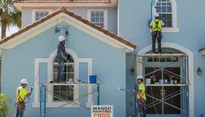 Lakeland, FL painters preparing a home exterior for professional painting service